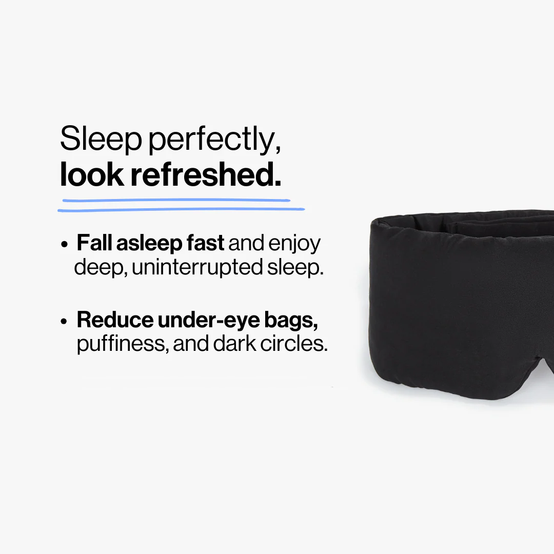 Model wearing black deep sleep mask while relaxing in bed